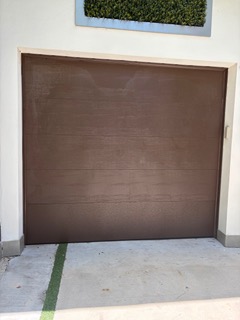 Single brown flush panel garage door installation
